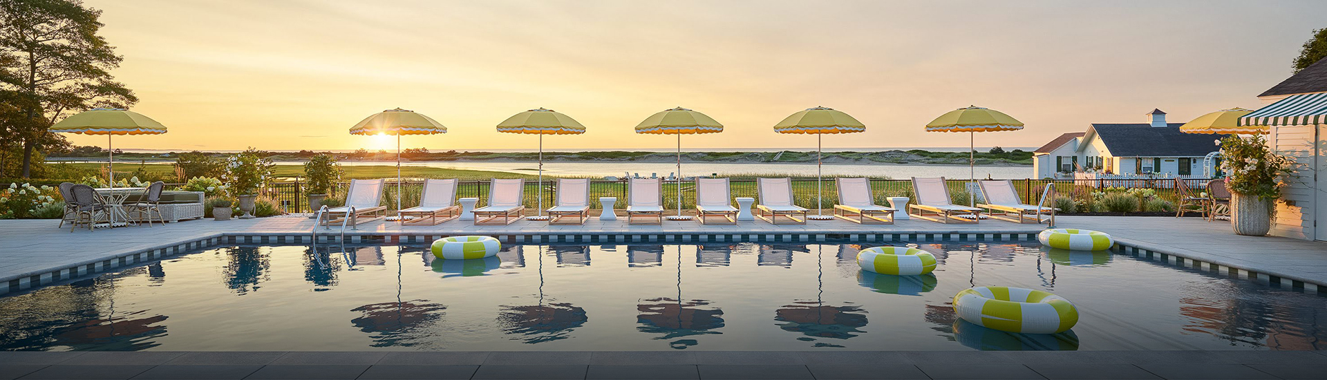 a pool with chairs and umbrellas