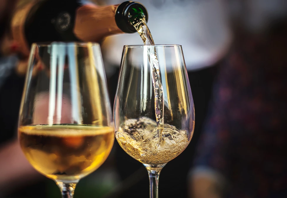 close view of a person serving a glass of wine