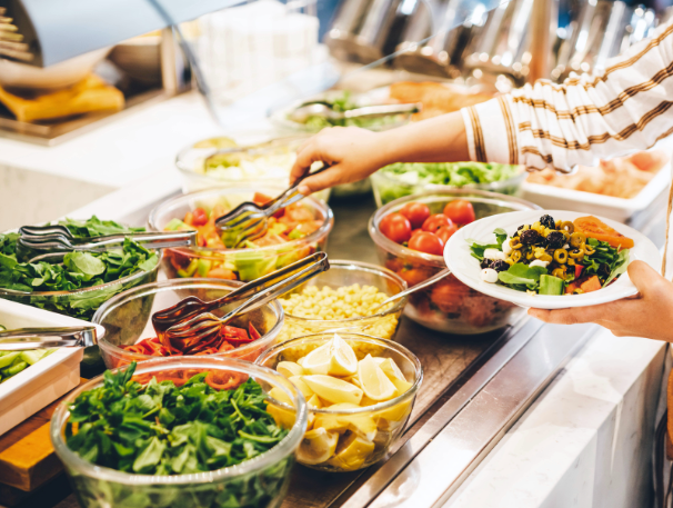 a person holding a plate of food