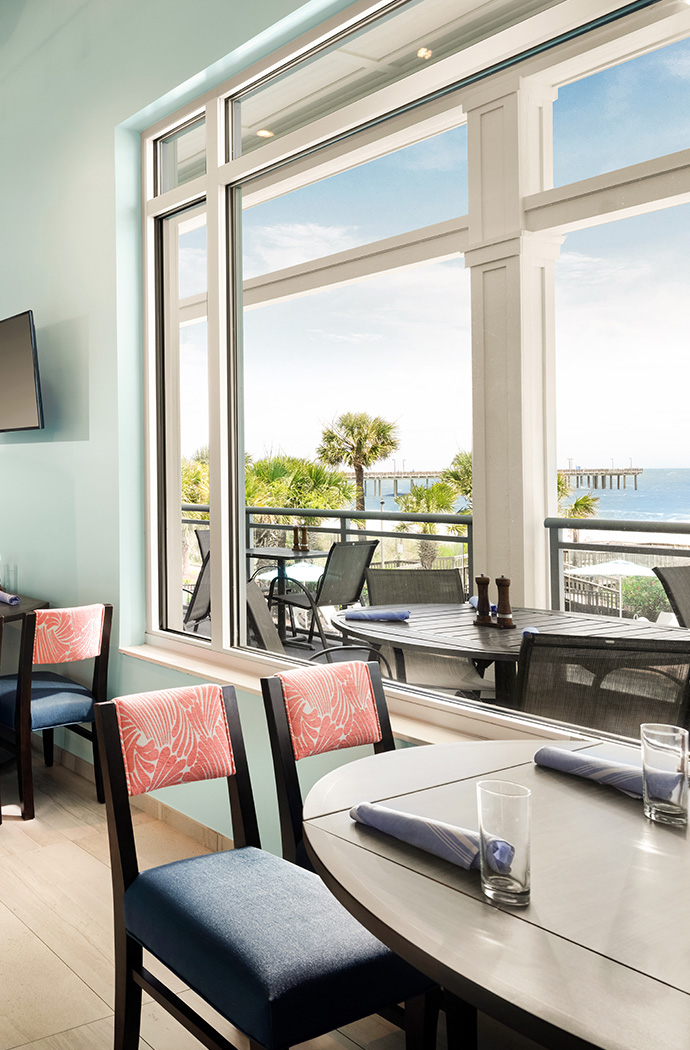 a room with a table and chairs and a television