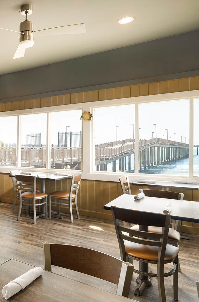 a room with tables and chairs and a pier