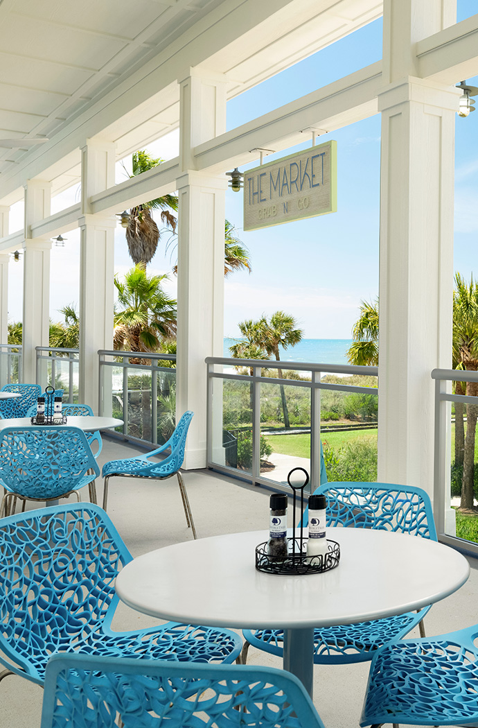 a restaurant with blue chairs and tables