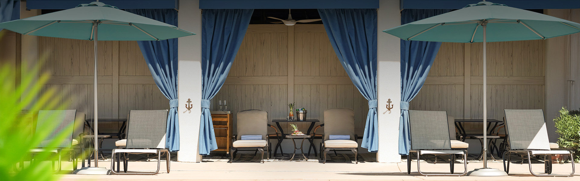 a table and chairs under a blue curtain