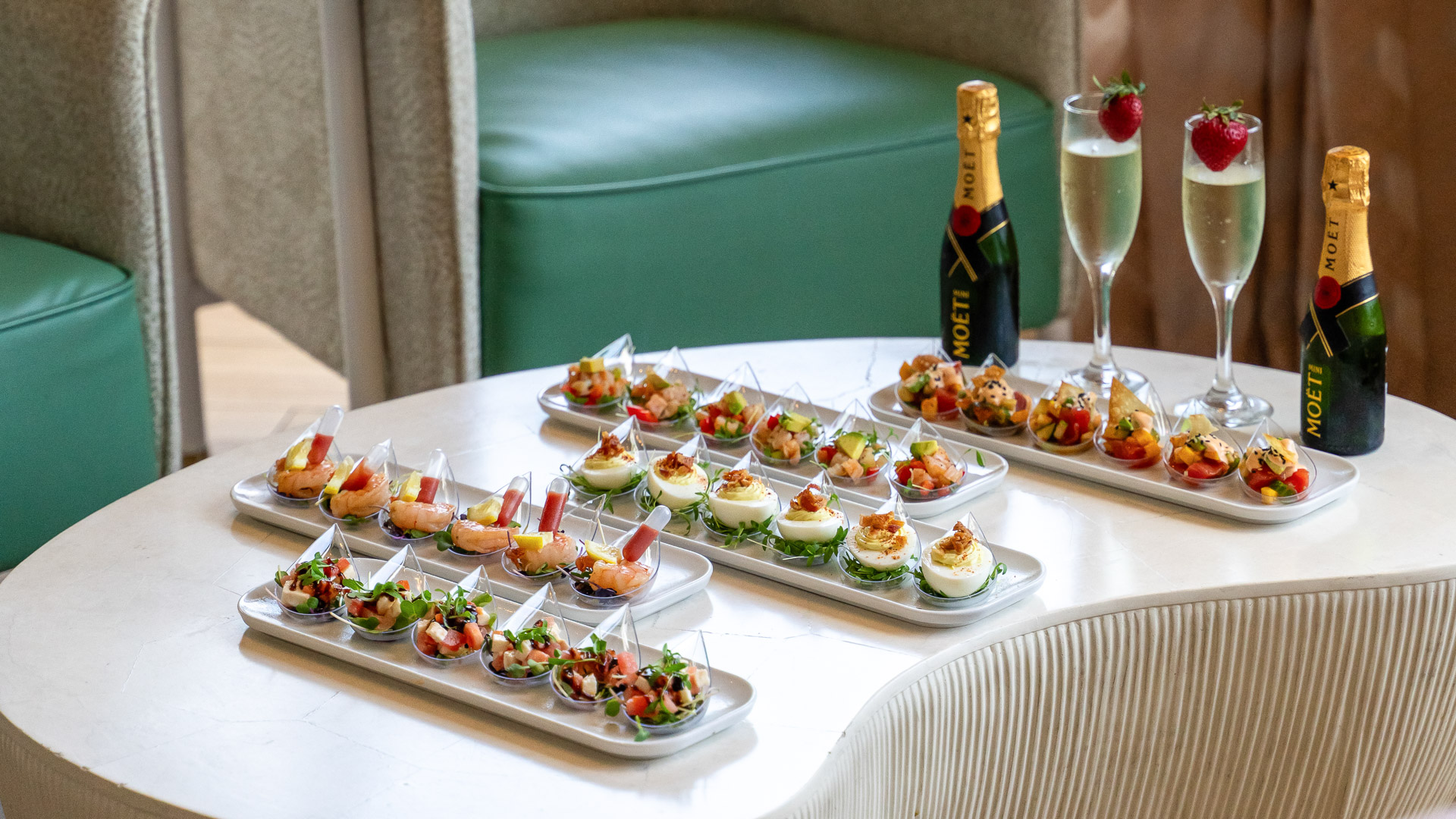 a table with plates of food and champagne