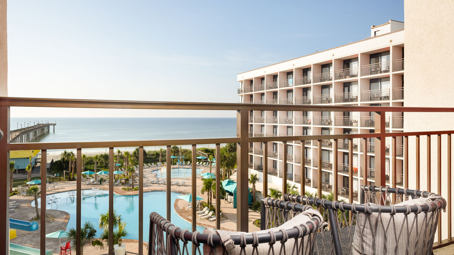 a balcony with a pool and a building