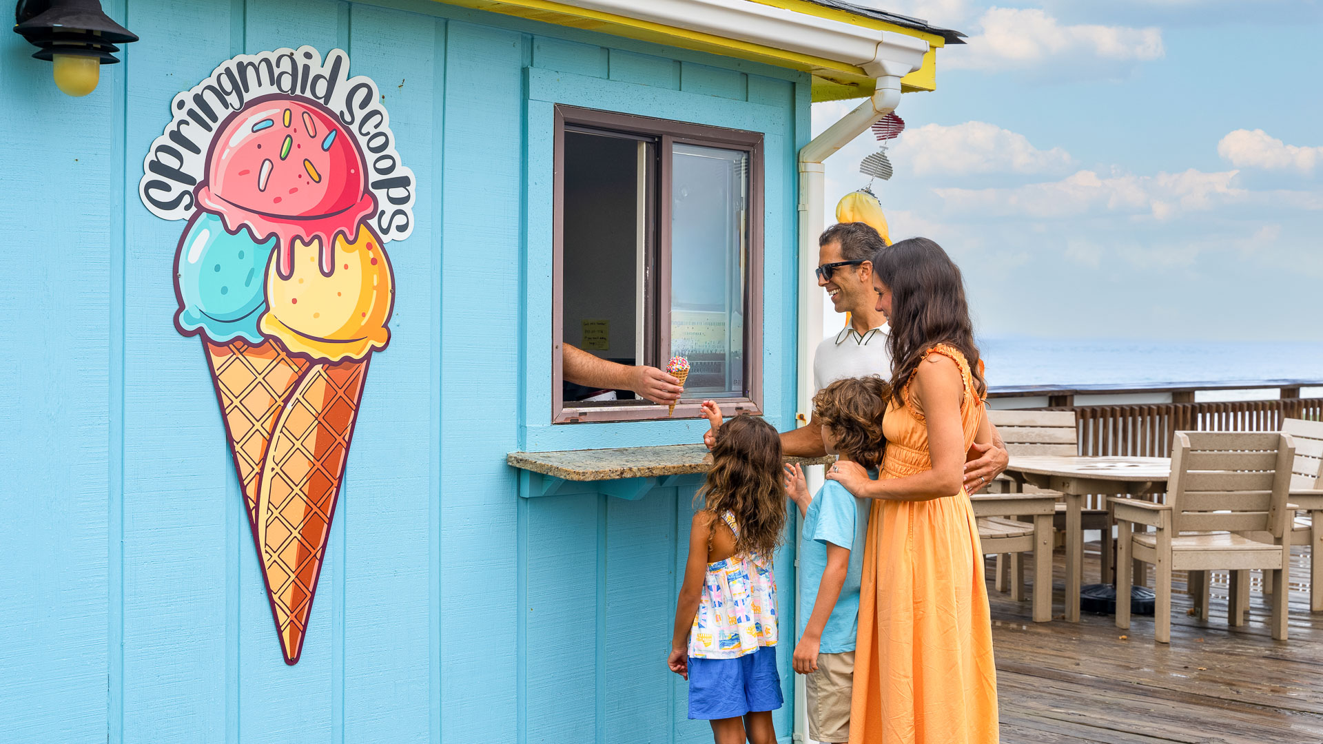 a group of people standing in front of a blue building