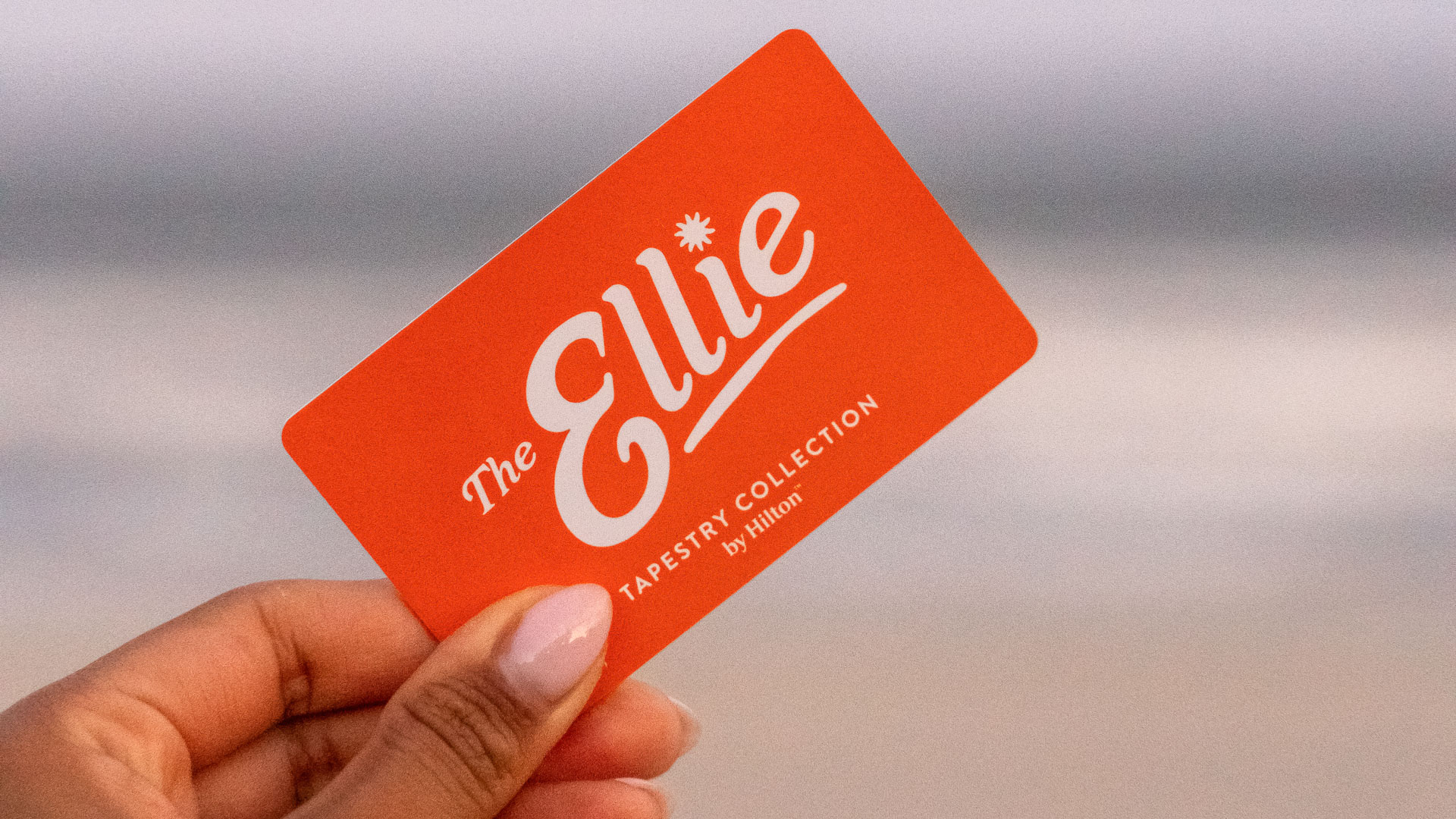 a hand holding an orange card