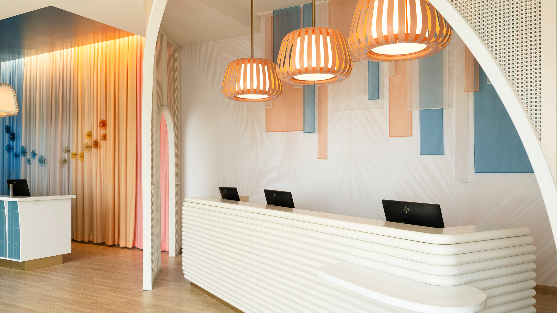 a reception desk with a light from the ceiling