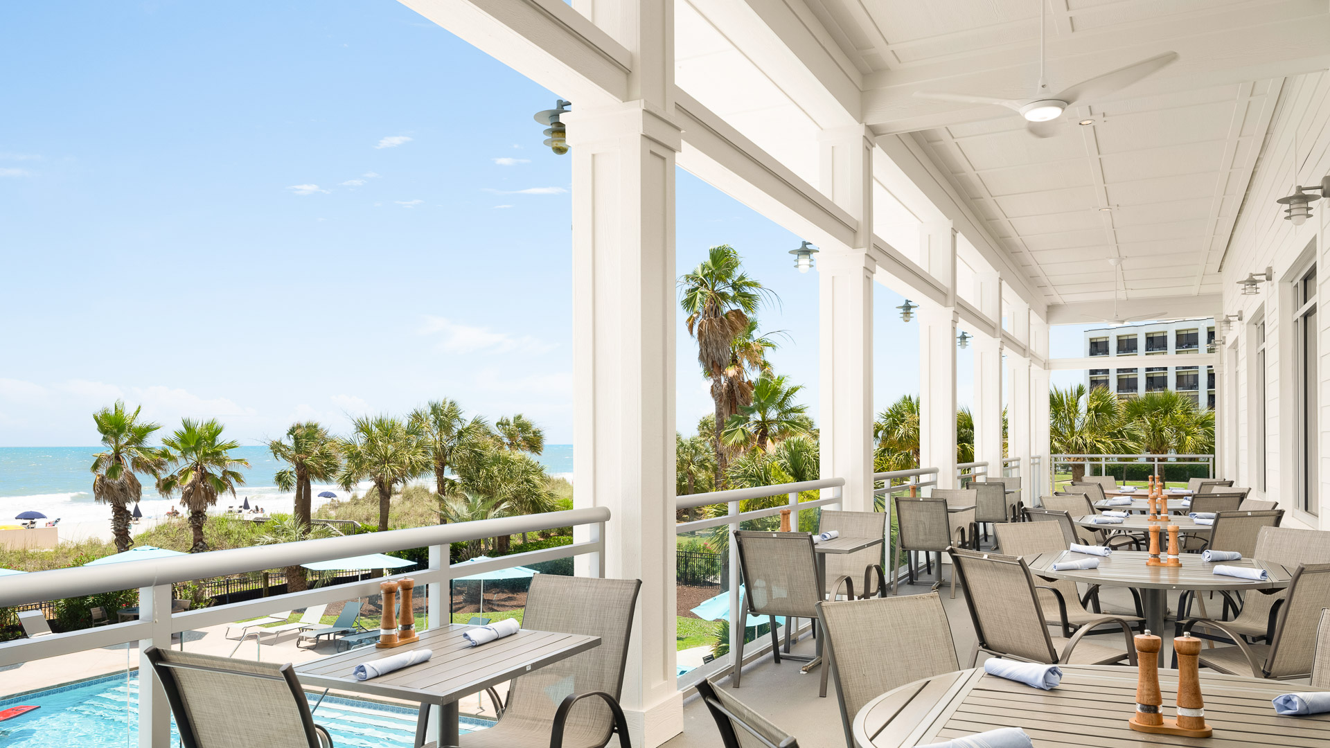 a patio with tables and chairs