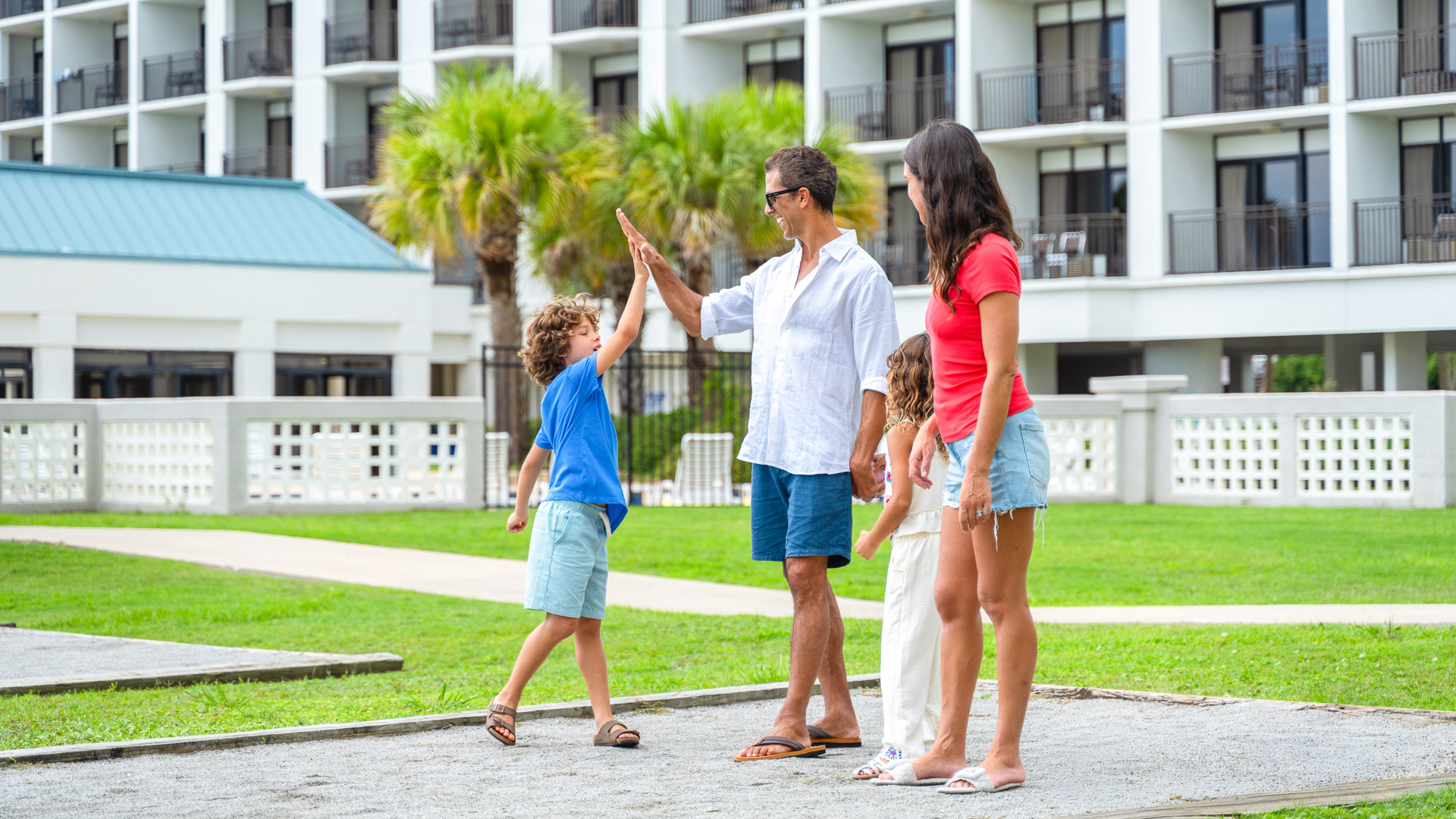 a man and woman giving a high five to a child