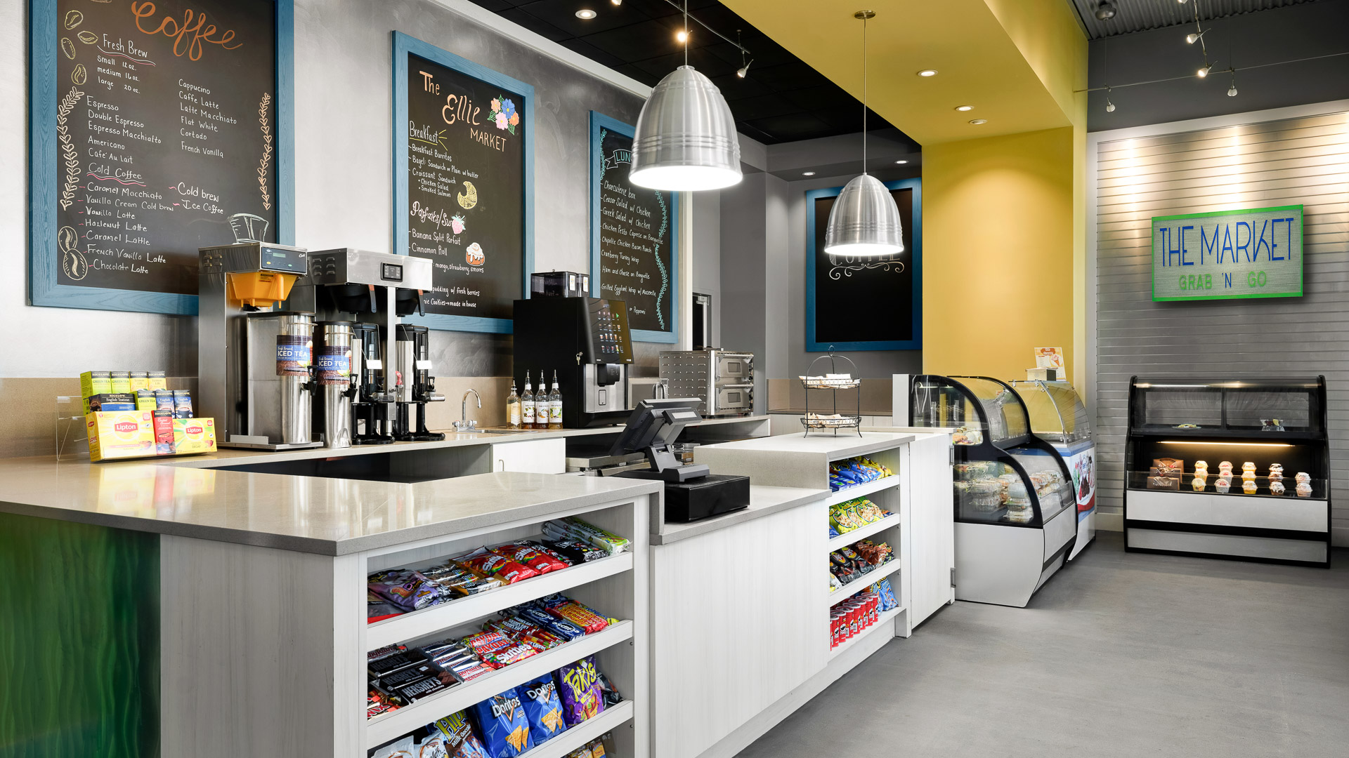 a coffee shop with a variety of snacks and a display case