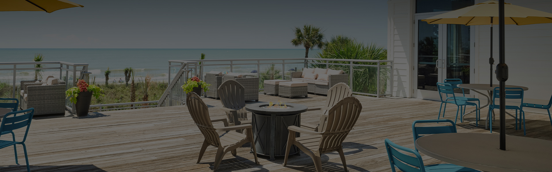 a patio with chairs and a fire pit