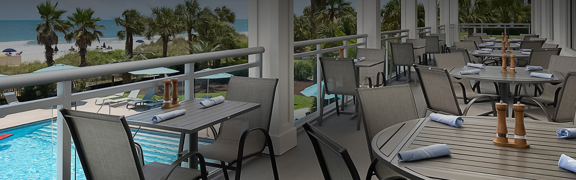 a patio with chairs and tables