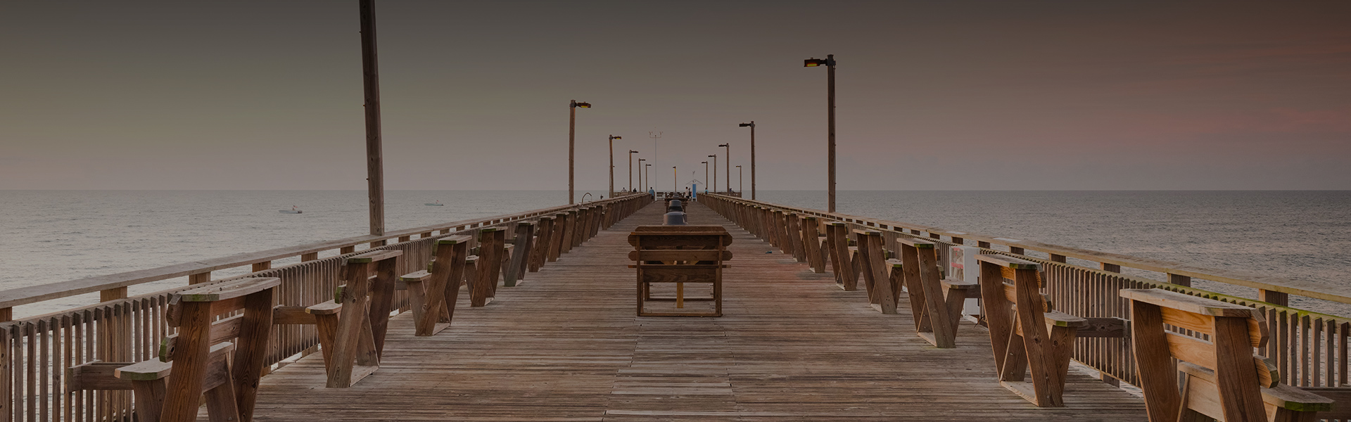 a wooden pier with a bench and a bench