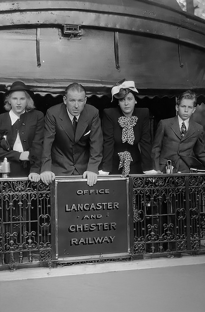 a group of people standing in front of a railing
