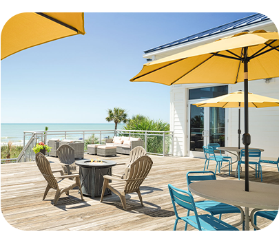 a patio with chairs and umbrellas