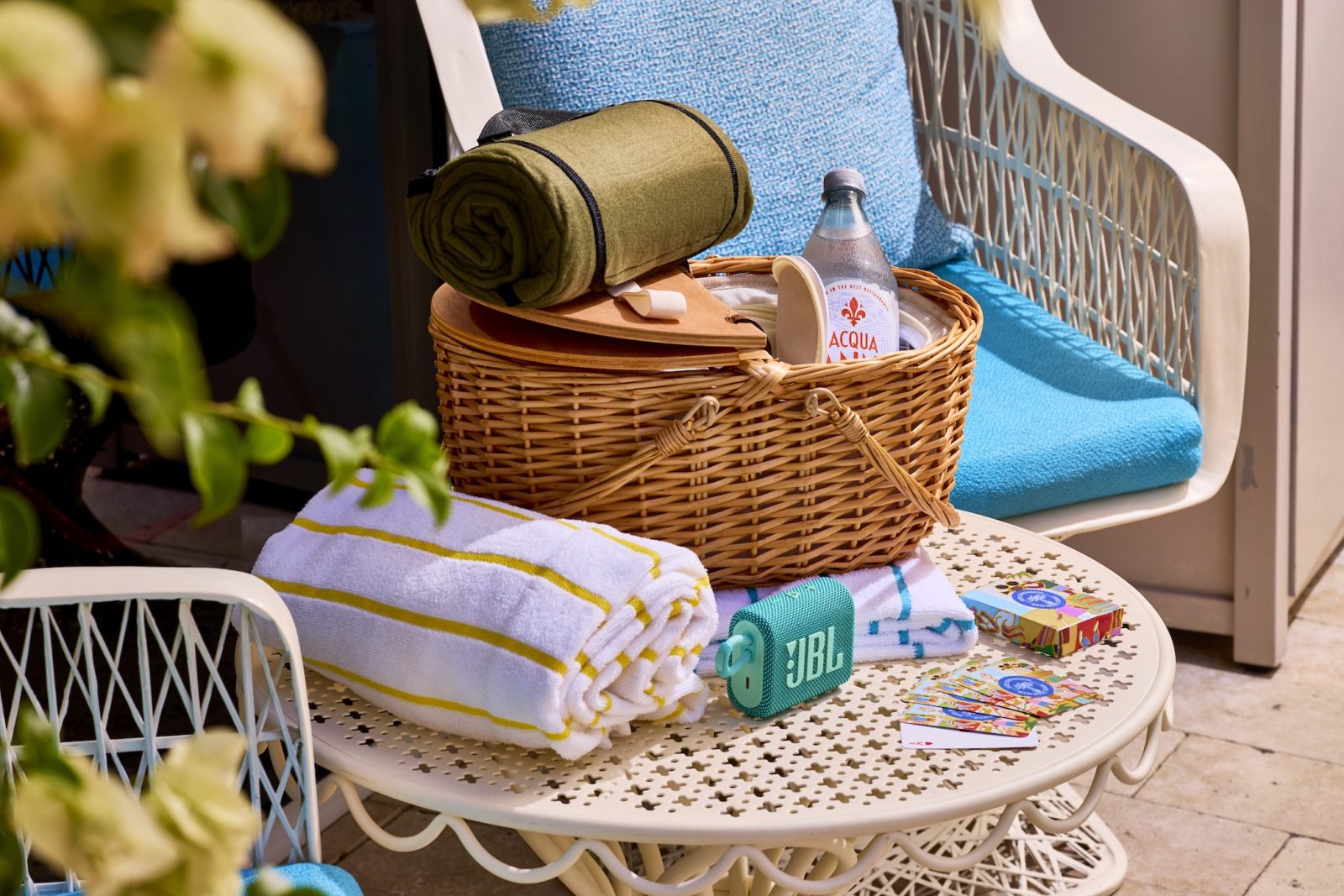 a picnic basket and towels on a table