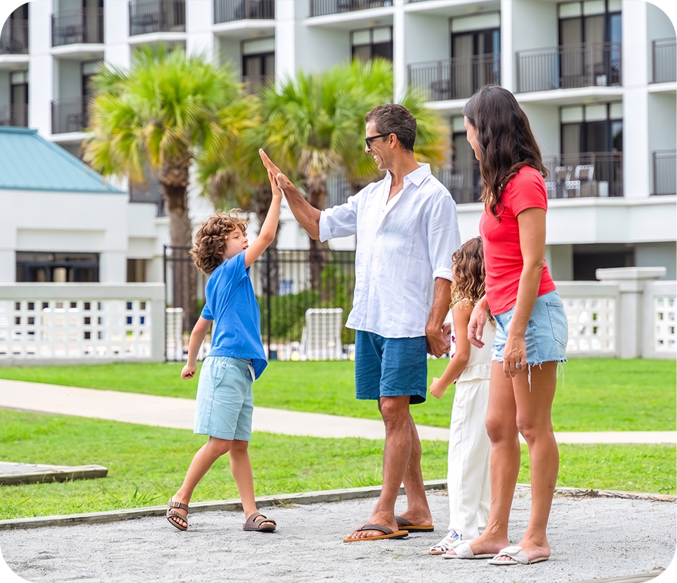 a man and woman giving a high five to a child