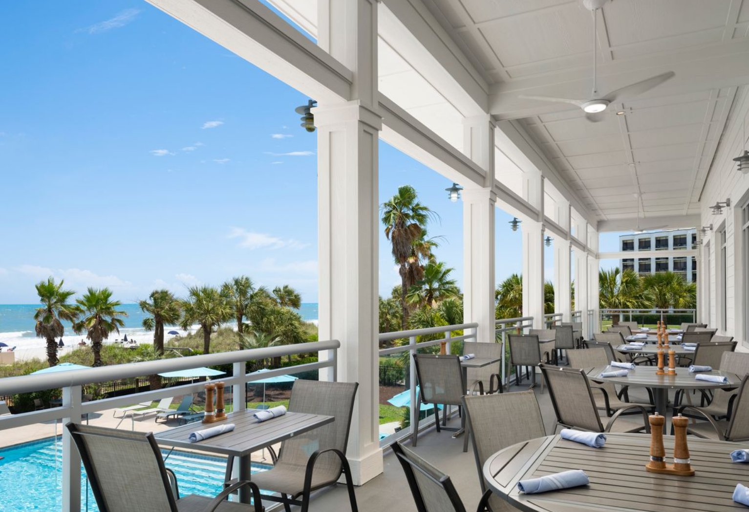 a patio with tables and chairs