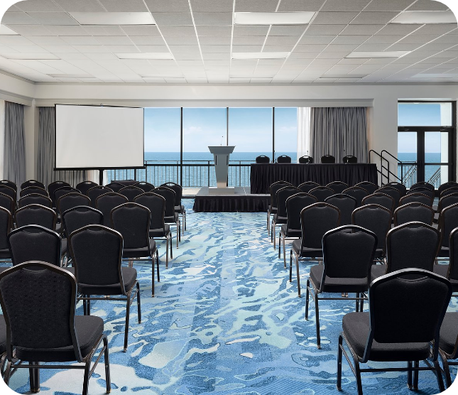 a room with chairs and a projector screen