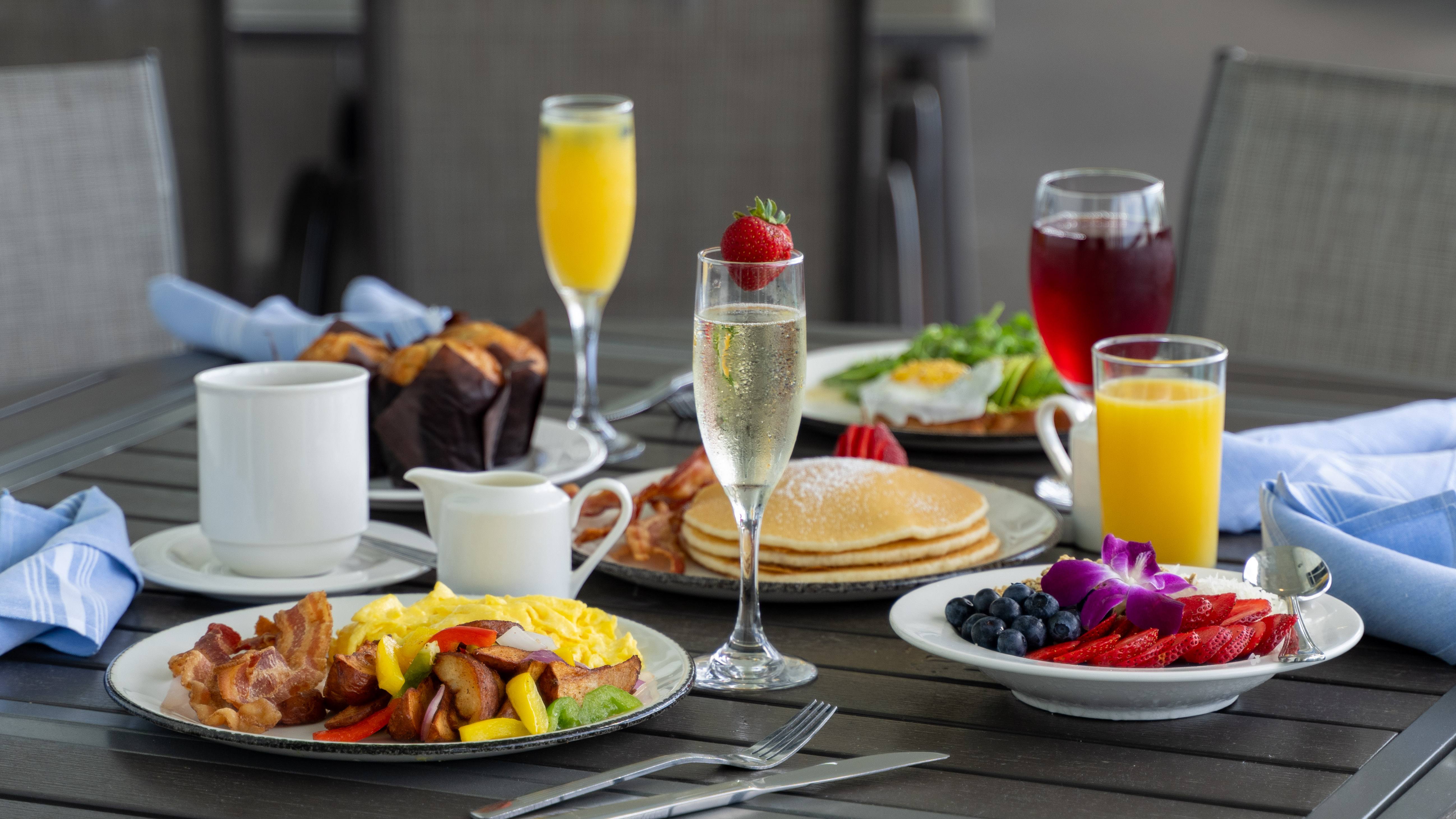 a table with plates of food and drinks
