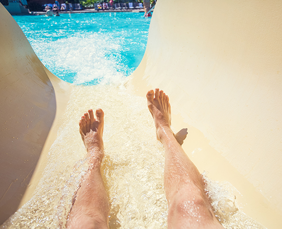 a person's legs on a water slide
