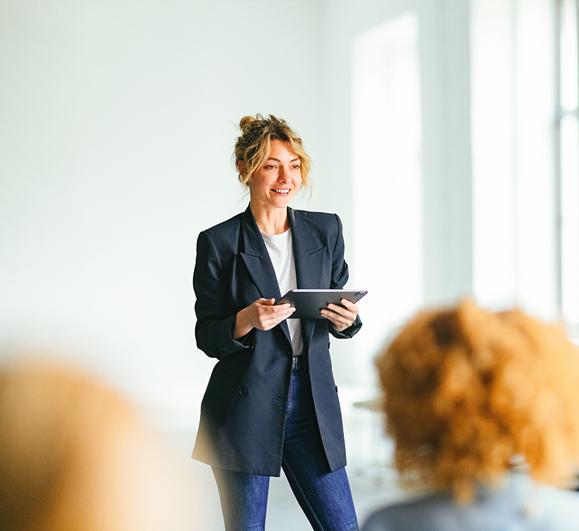 a woman standing in front of a group of people