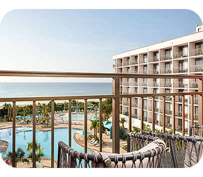 a balcony with a pool and a building