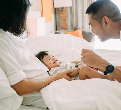 a man and woman holding a baby