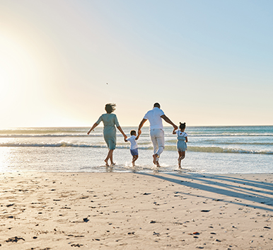 a family running on a beach