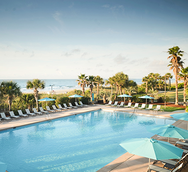 a pool with umbrellas and chairs