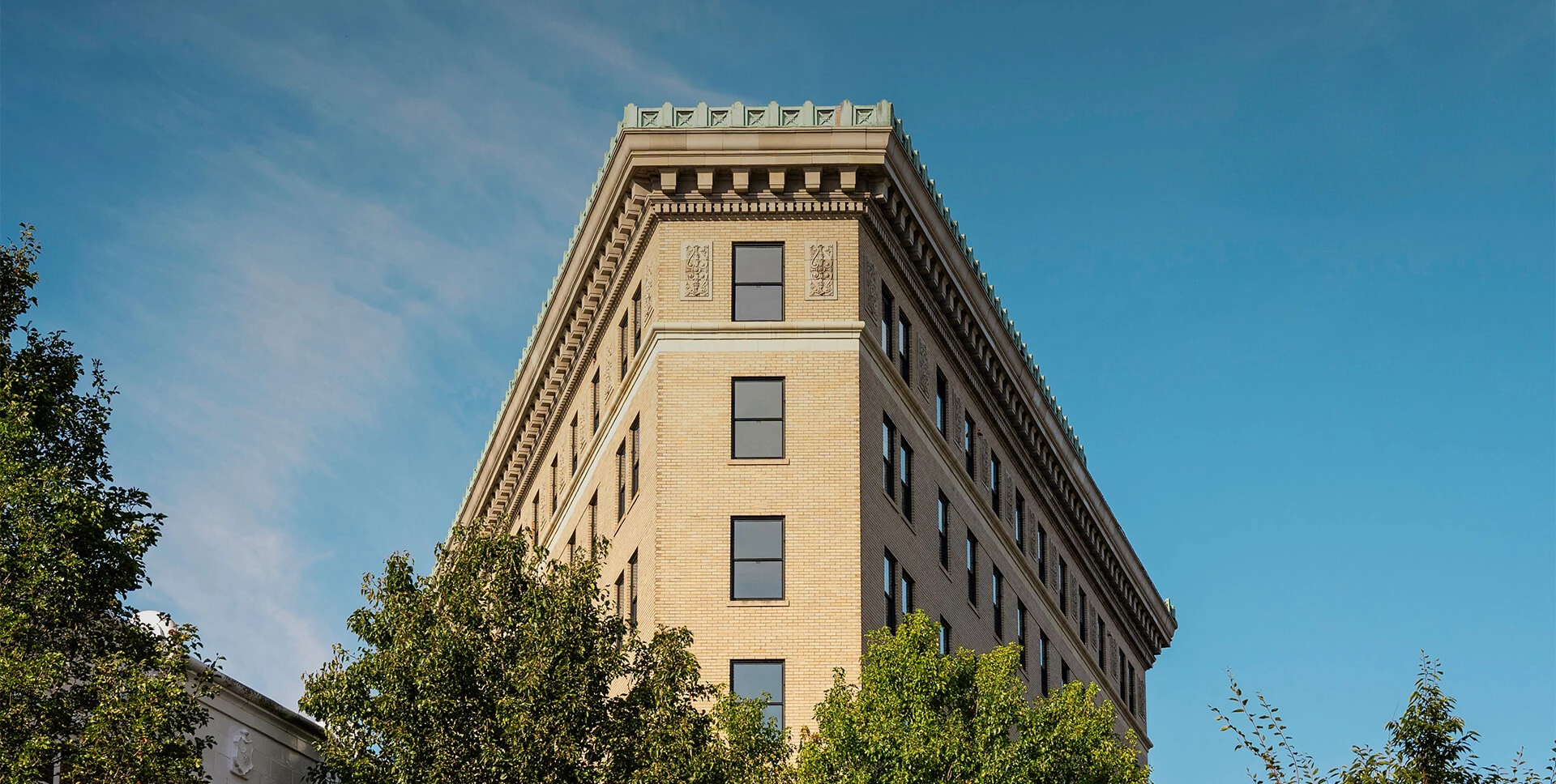 a tall building with trees in front of it