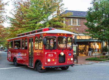 a red trolley on the street