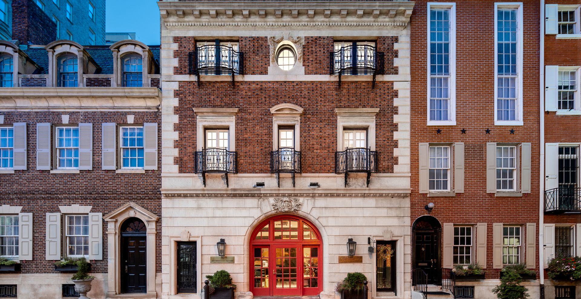 hero image for a building with a red door and windows