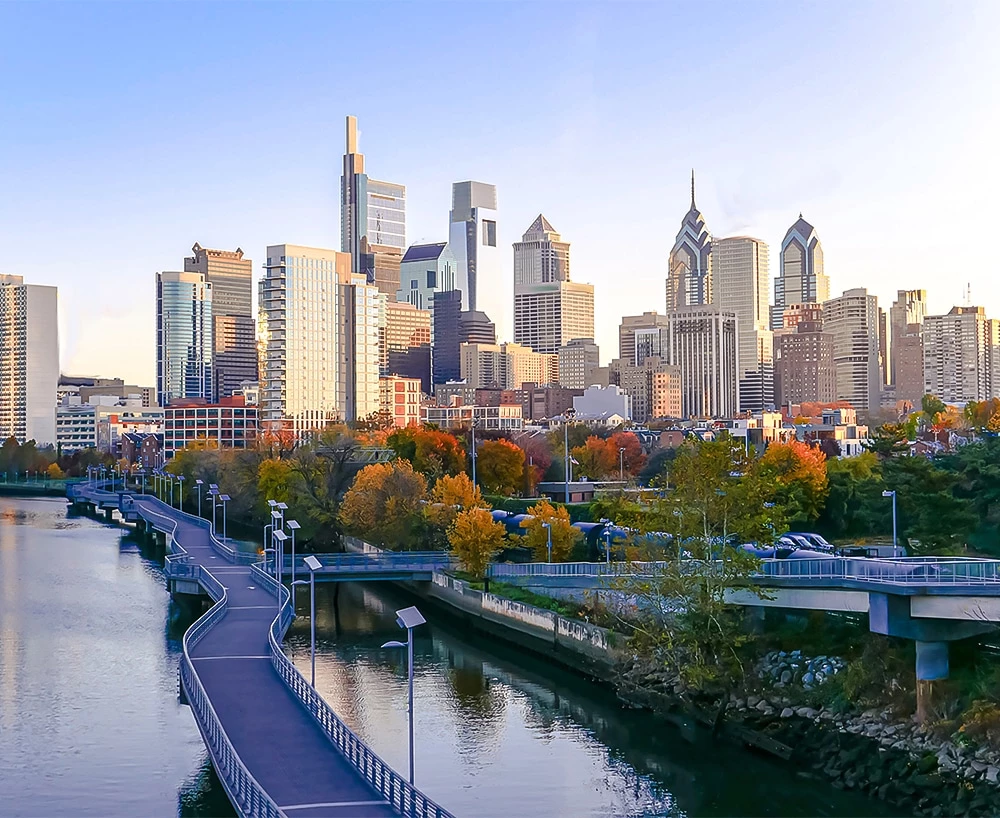 Post image for a bridge over a river with a city in the background