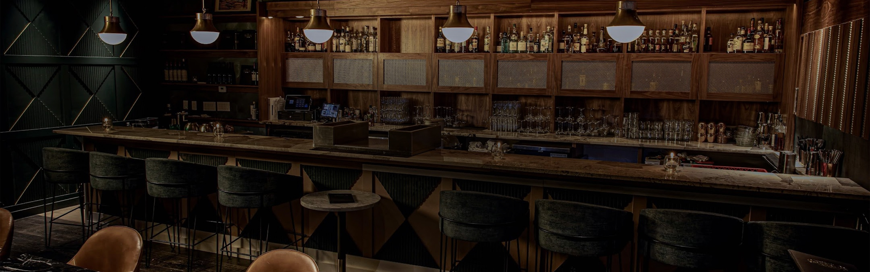 a bar with a counter and chairs