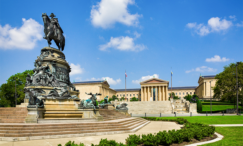 Post image for a statue of a man on a horse in front of a building