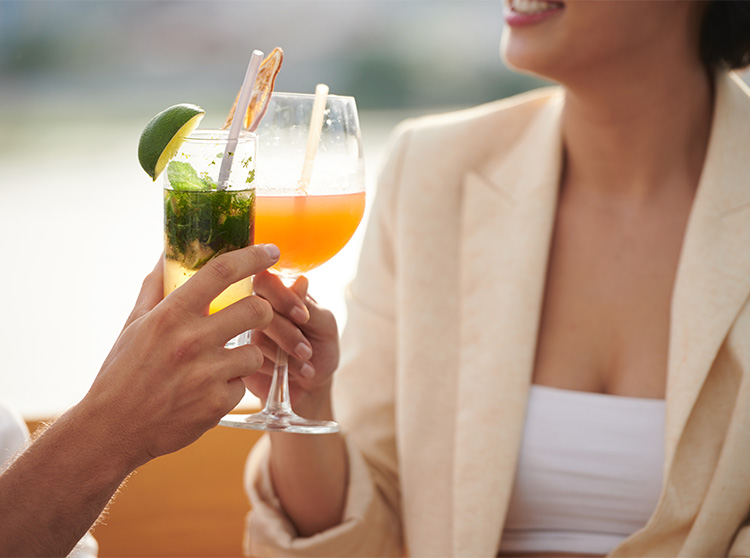 a couple of people holding drinks
