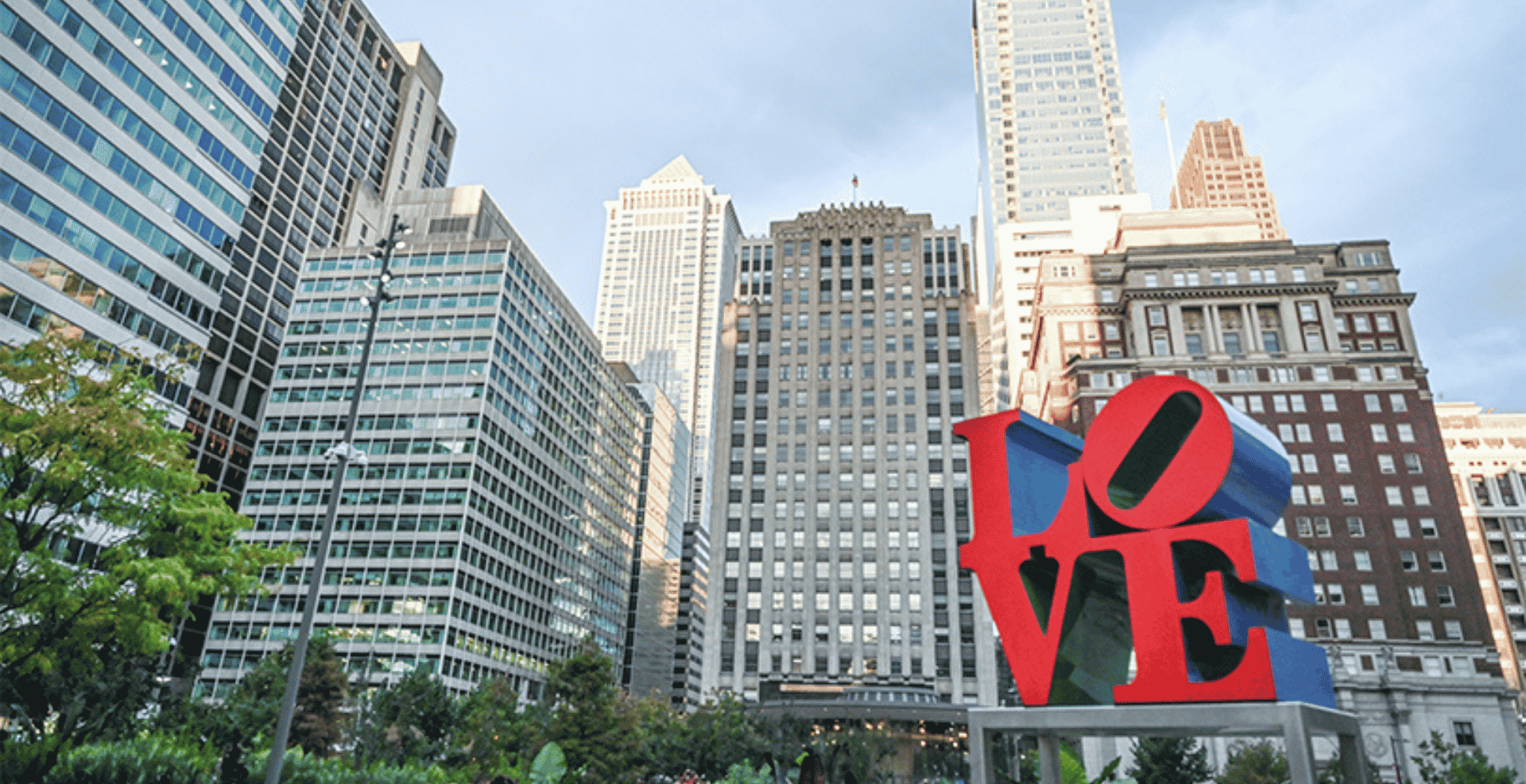 a large red sign in front of a city