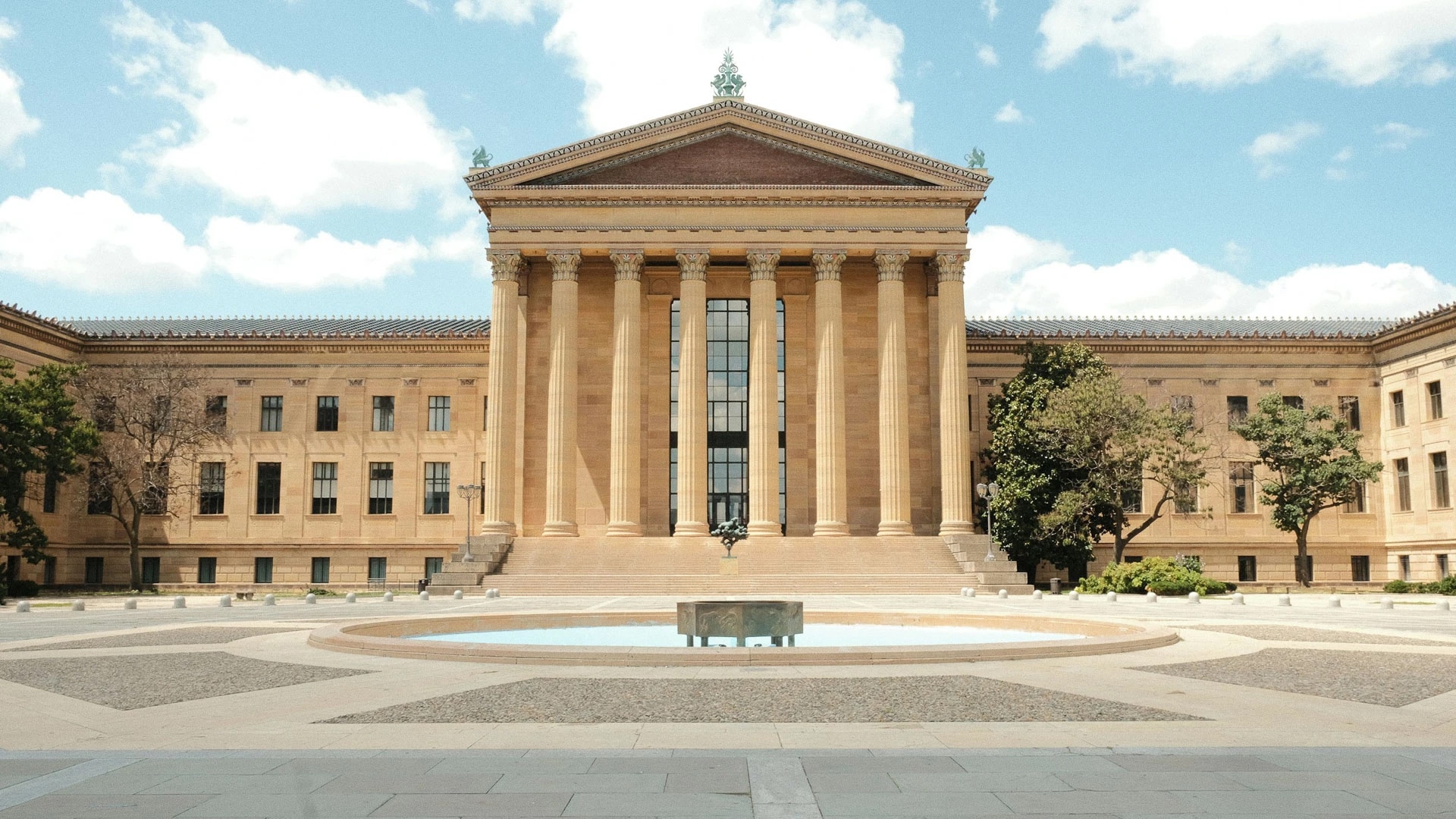 Post image for a large building with columns and a fountain with Philadelphia Museum of Art in the background