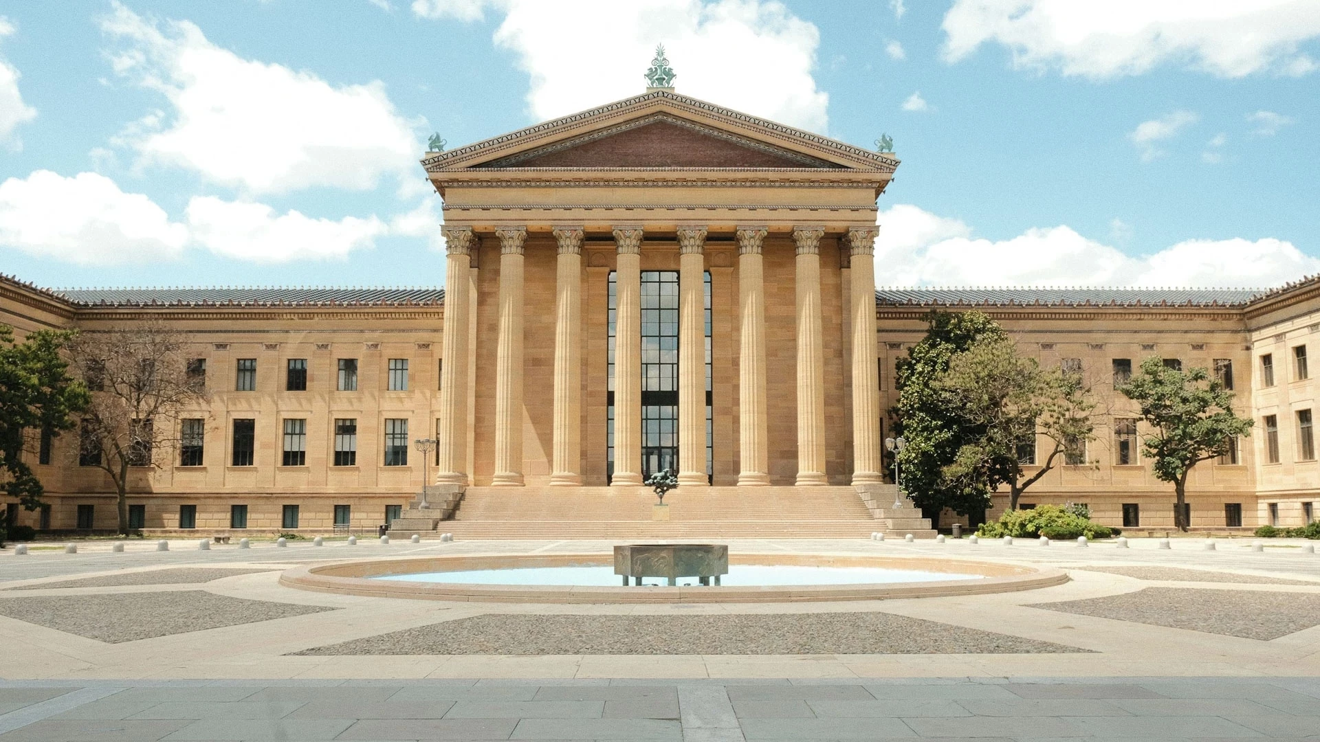 Post image for a large building with columns and a fountain with Philadelphia Museum of Art in the background