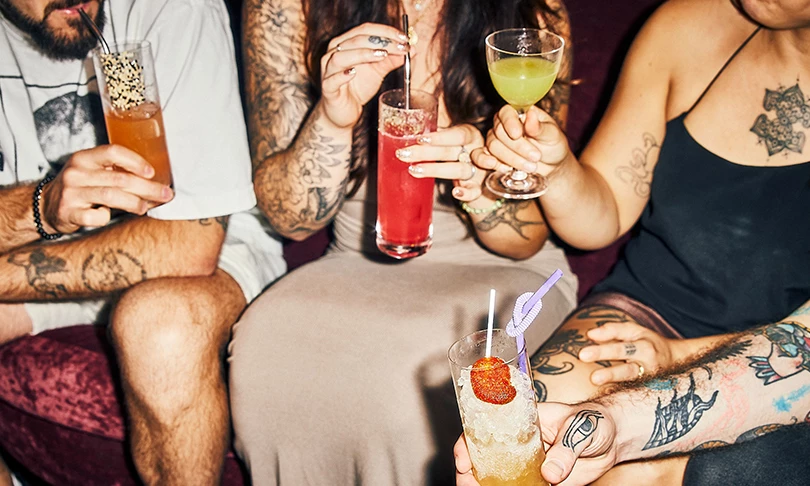 a group of people holding drinks
