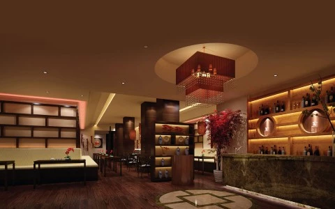 A luxurious hotel lobby with a bar, seating area, and decorative elements.