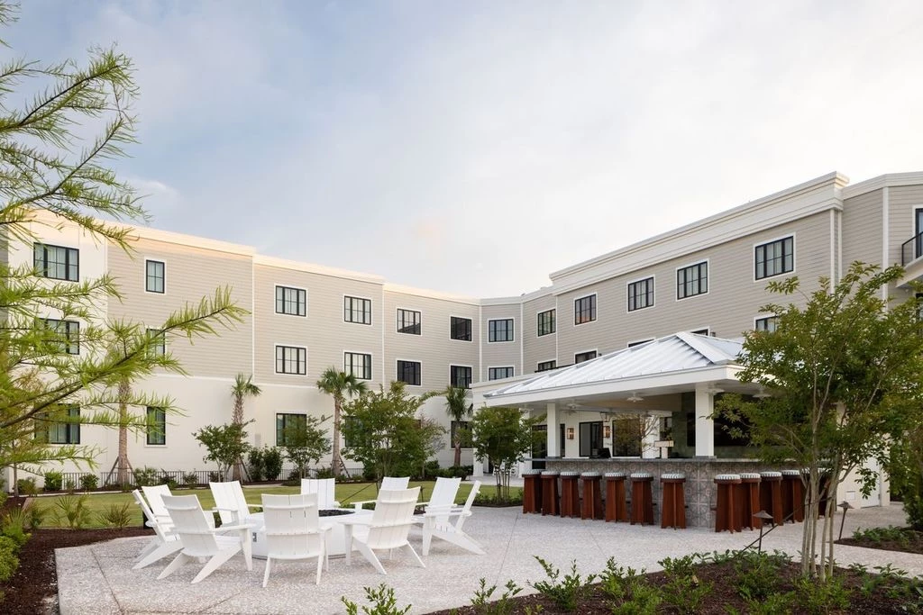 a large building with a patio and chairs