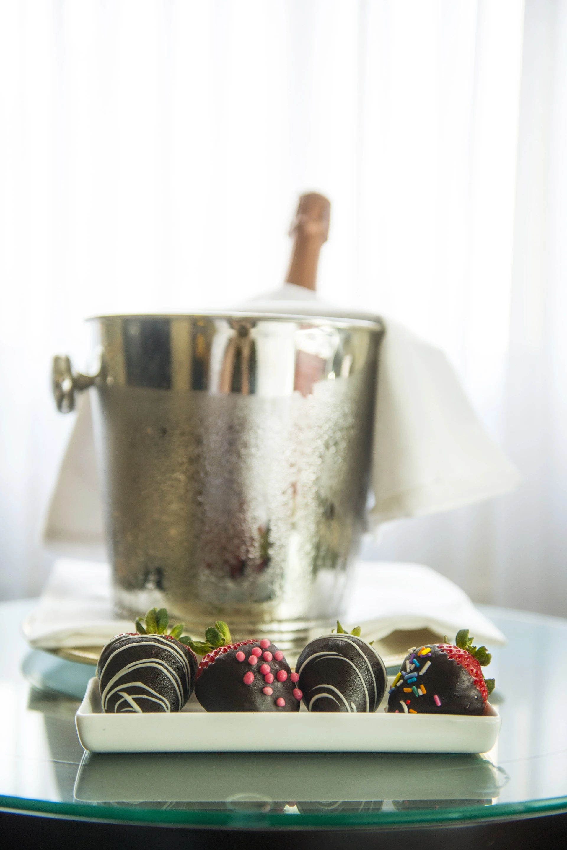 chocolate covered strawberries with chocolate icing and sprinkles on a table