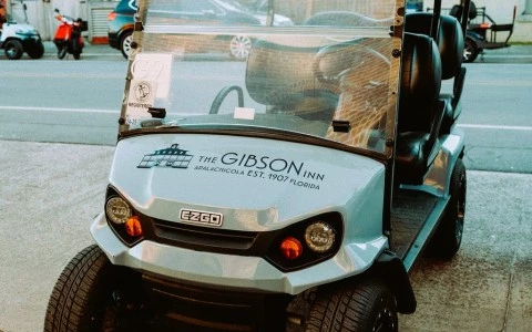 a golf cart parked on the pavement