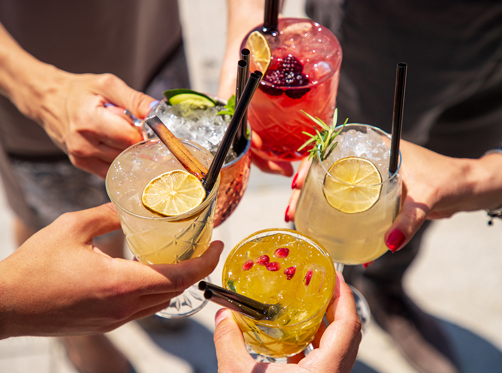 a group of hands holding drinks