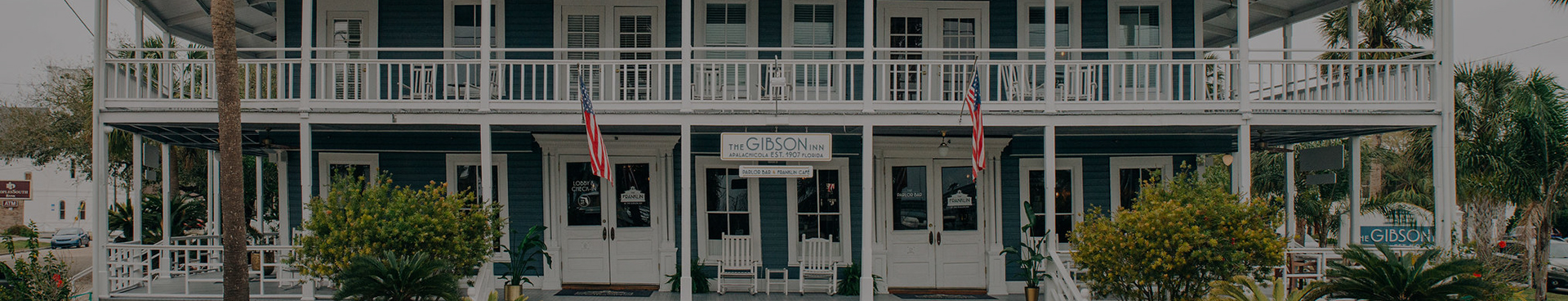 a building with white chairs and a sign