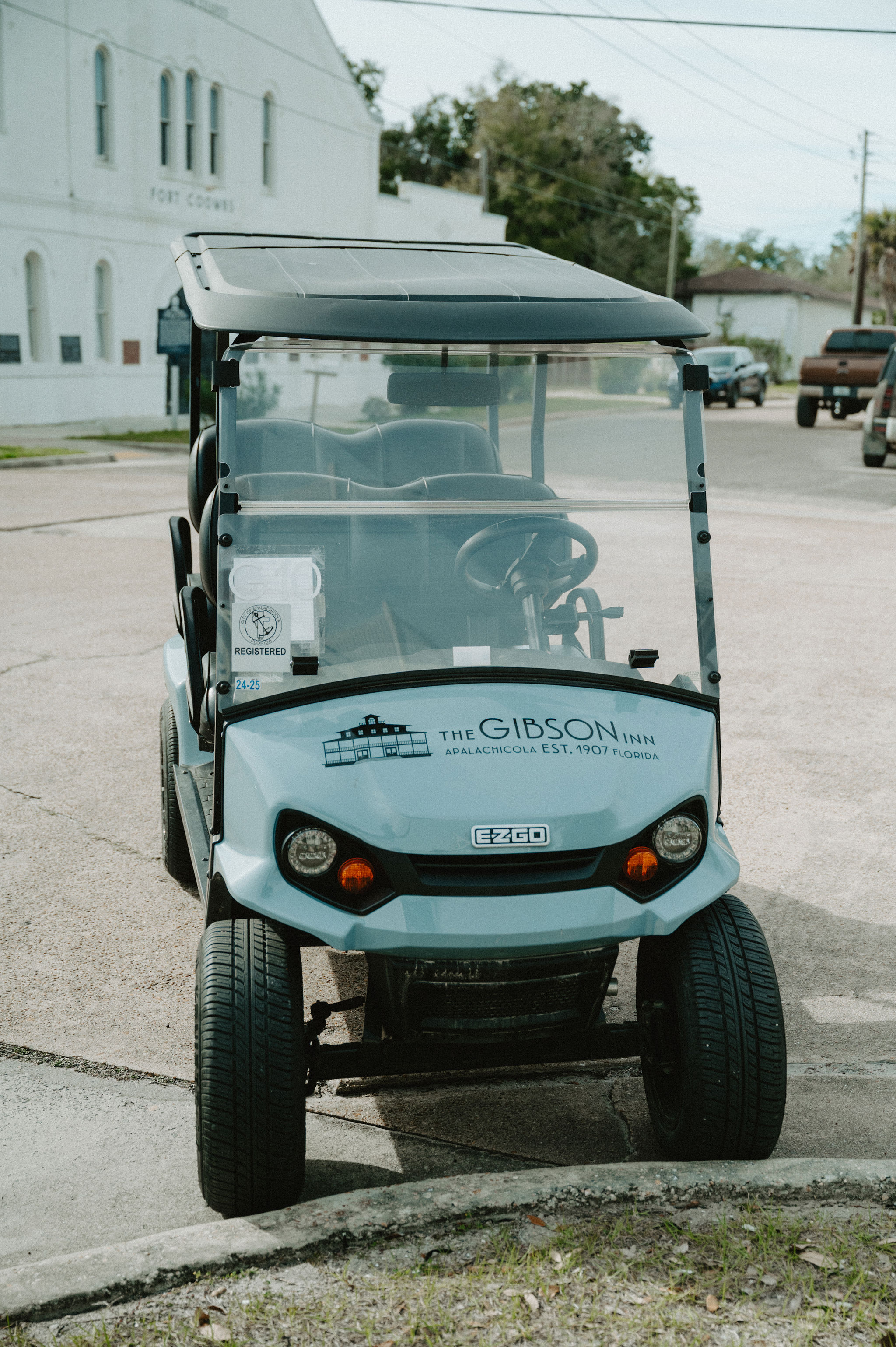 a small golf cart parked in a parking lot