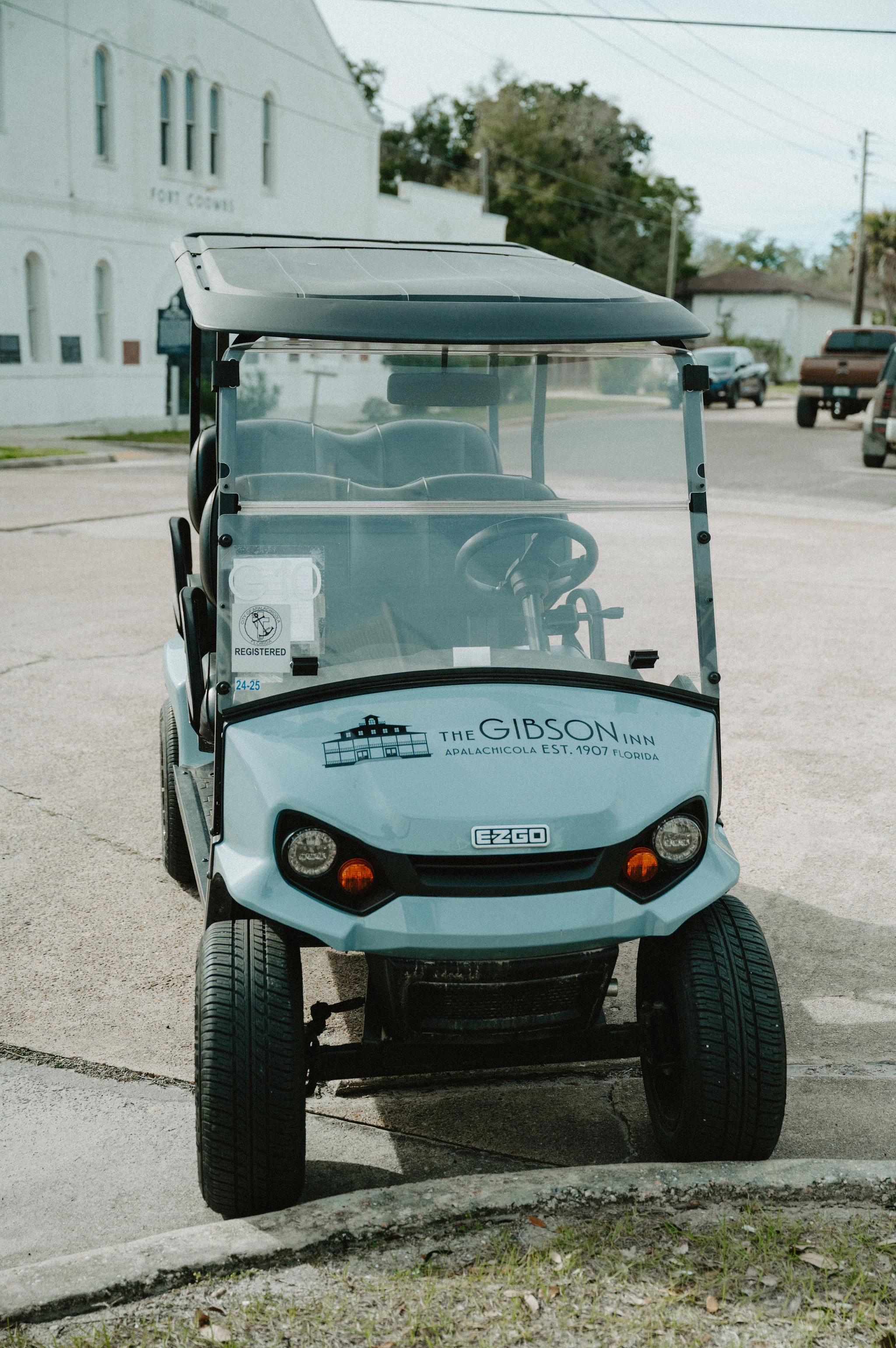 a small golf cart parked in a parking lot